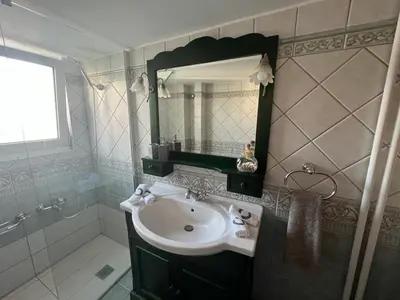 a bathroom with a sink and a mirror at glyfada luxury home in Athens