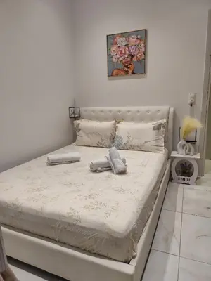 a bed with two towels on it in a bedroom at The loft in Piraeus
