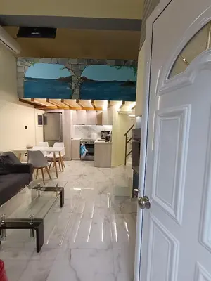 a living room with a couch and a table at The loft in Piraeus
