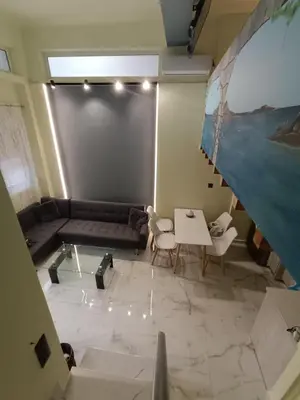 a living room with a couch and a table at The loft in Piraeus