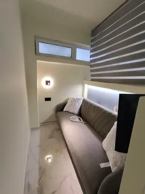 a living room with a couch and a window at The loft in Piraeus