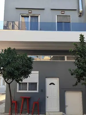 a building with two red stools in front of it at The loft in Piraeus