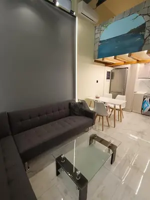 a living room with a couch and a table at The loft in Piraeus