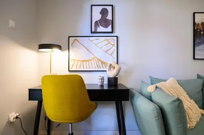 a living room with a yellow chair and a desk at Cosy Contemporary Luxury Urban Retreat in Athens in Athens
