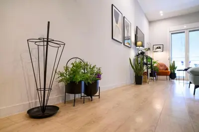 a living room with potted plants on the floor at Cosy Contemporary Luxury Urban Retreat in Athens in Athens
