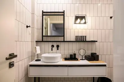 a bathroom with a sink and a mirror at Cosy Contemporary Luxury Urban Retreat in Athens in Athens