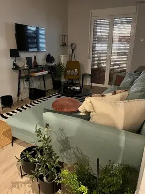 a living room with a couch and some plants at Cosy Contemporary Luxury Urban Retreat in Athens in Athens
