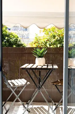 a table with a potted plant on a patio at Sunlit Serenity Cozy 1bdrm Escape in Athens in Athens