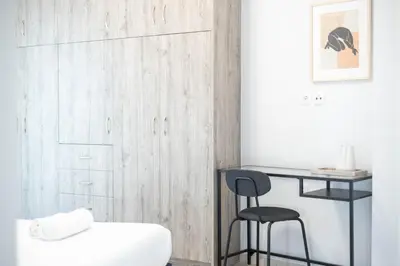a room with a desk and a stool next to a closet at Sunlit Serenity Cozy 1bdrm Escape in Athens in Athens
