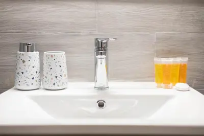 a bathroom sink with two glasses of orange juice at Sunlit Serenity Cozy 1bdrm Escape in Athens in Athens