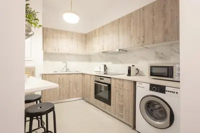 a kitchen with a washer and dryer in it at Sunlit Serenity Cozy 1bdrm Escape in Athens in Athens