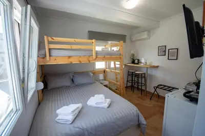 a small room with a bunk bed and a window at Birdhouse Apartment Athens in Athens