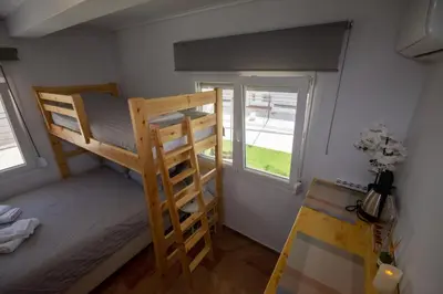 a bedroom with two bunk beds and a window at Birdhouse Apartment Athens in Athens