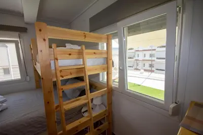a bunk bed in a room with a window at Birdhouse Apartment Athens in Athens