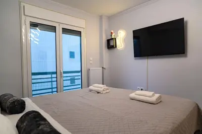 a bedroom with a bed with two towels on it at Fresh Spicy 1bd Amusement Arcade in Athens
