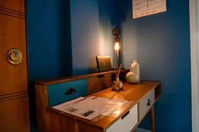a room with a wooden desk with a blue wall at BlueXenia 1 bedroom Retro Luxury in Athens