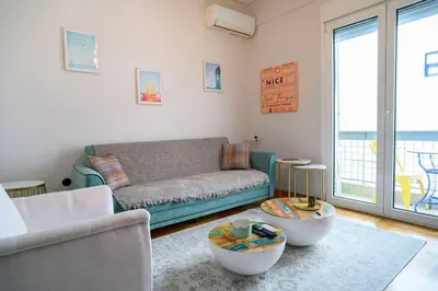 a living room with a couch and a table at BlueXenia 1 bedroom Retro Luxury in Athens