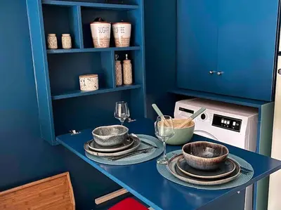 a blue kitchen with a table with plates and wine glasses at BlueXenia 1 bedroom Retro Luxury in Athens