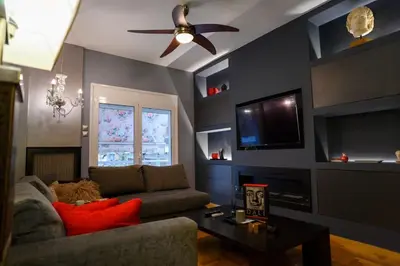 a living room with a couch and a ceiling fan at Metropolitan prestigious 2 bedroom luxury in Athens