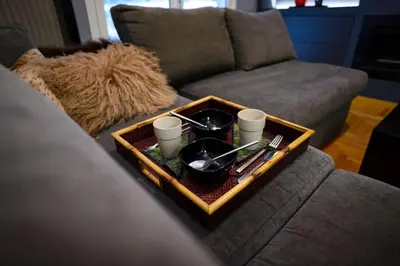 a tray with dishes and cups on a couch at Metropolitan prestigious 2 bedroom luxury in Athens