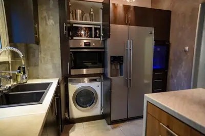 a kitchen with a refrigerator and a washing machine at Metropolitan prestigious 2 bedroom luxury in Athens