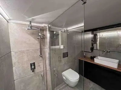 a bathroom with a shower and a toilet and a sink at Metropolitan prestigious 2 bedroom luxury in Athens