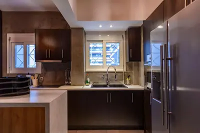 a kitchen with a sink and a refrigerator at Metropolitan prestigious 2 bedroom luxury in Athens