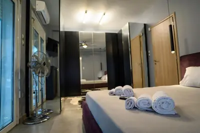 a hotel room with a bed with towels on it at Metropolitan prestigious 2 bedroom luxury in Athens