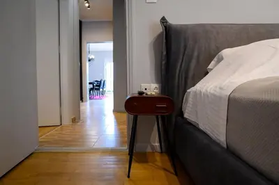 a bedroom with a bed and a table next to it at Seaview Orchid 2 bed Elegance in Athens