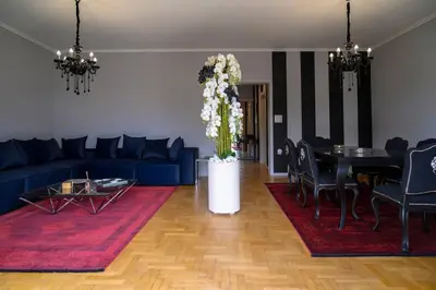 a living room with a blue couch and a table at Seaview Orchid 2 bed Elegance in Athens
