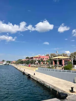 a pier next to a body of water with buildings at Seaview Orchid 2 bed Elegance in Athens