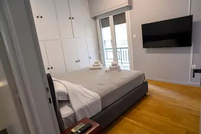 a bedroom with a large bed with a television at Seaview Orchid 2 bed Elegance in Athens