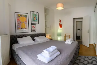 a bedroom with a large bed with towels on it at Debonair 1 bedroom premium haven in Athens in Athens