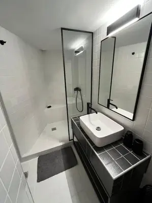 a bathroom with a sink and a shower and a mirror at Debonair 1 bedroom premium haven in Athens in Athens