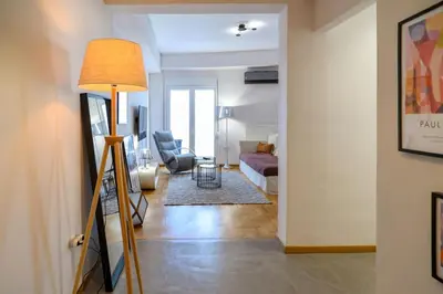 a living room with a lamp and a couch at Debonair 1 bedroom premium haven in Athens in Athens