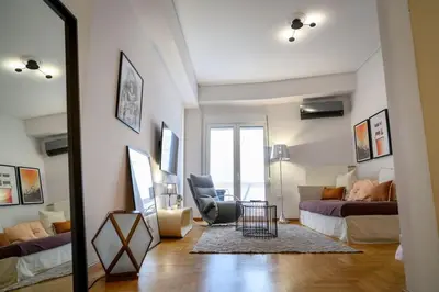 a living room with a couch and a bed at Debonair 1 bedroom premium haven in Athens in Athens