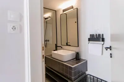 a bathroom with a sink and a mirror at Debonair 1 bedroom premium haven in Athens in Athens