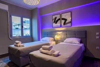 two beds in a room with purple lighting at Subtle 3 bed Luxury with a View in Athens