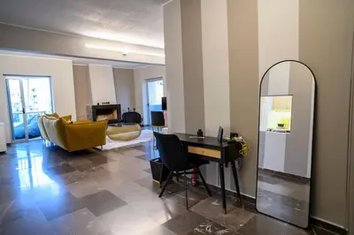 a living room with a mirror and a table at Subtle 3 bed Luxury with a View in Athens