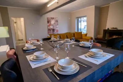 a table with plates and wine glasses on it at Subtle 3 bed Luxury with a View in Athens