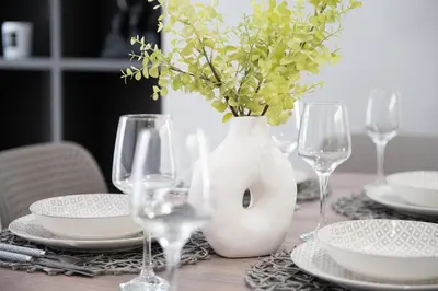 a table with a white vase with flowers in it at Elegant 3BR apartment in the heart of Athens (Form_19) in Athens
