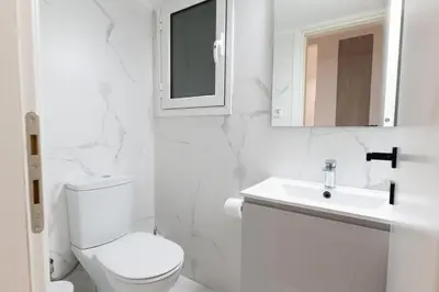 a white bathroom with a toilet and a sink at Elegant 3BR apartment in the heart of Athens (Form_19) in Athens