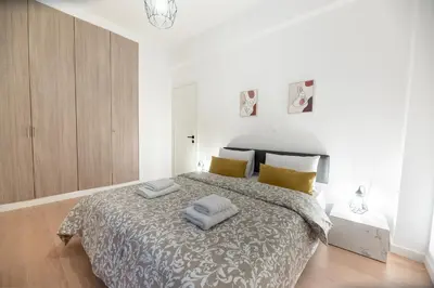 a bedroom with a large bed with two pillows on it at Elegant 3BR apartment in the heart of Athens (Form_19) in Athens