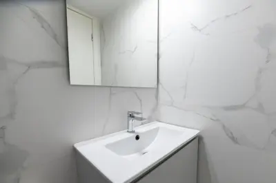 a white bathroom with a sink and a mirror at Elegant 3BR apartment in the heart of Athens (Form_19) in Athens