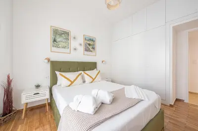 a bedroom with a bed with two towels on it at The Business Suite by CloudKeys in Athens