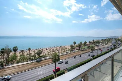 a view of a road and the ocean from a balcony at Breathtaking seaview studio in Athenian Riviera in Athens