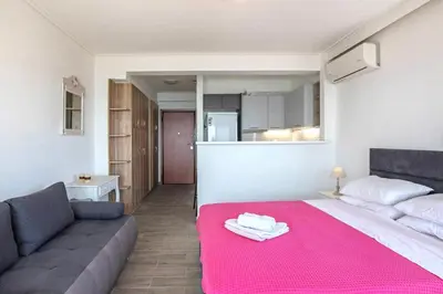 a living room with a bed and a couch at Breathtaking seaview studio in Athenian Riviera in Athens