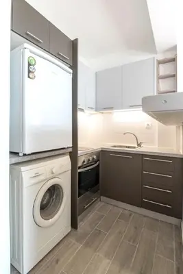 a kitchen with a washing machine and a sink at Breathtaking seaview studio in Athenian Riviera in Athens