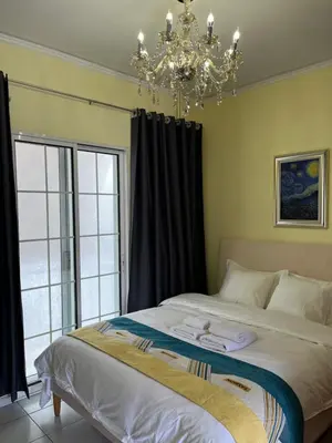 a bedroom with a large bed with a chandelier at Qqueen House in Piraeus