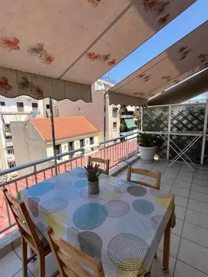 a table and chairs on a balcony with a view at Qqueen House in Piraeus